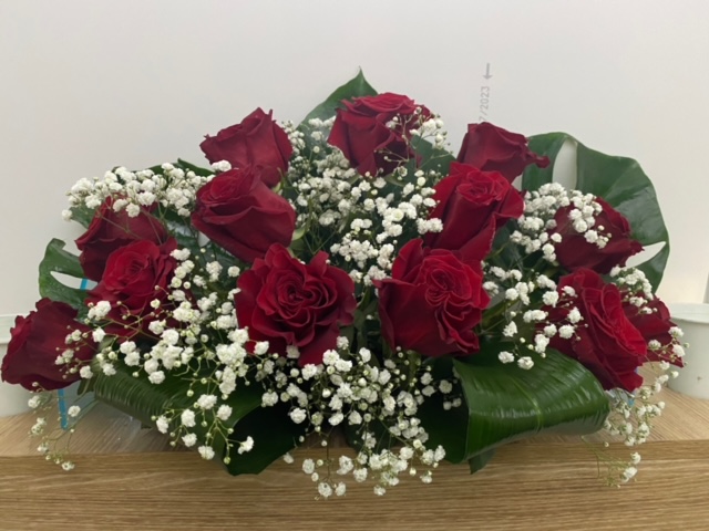 Centro delante del mostrador de la floristería San Ildefonso con en tonos rojos